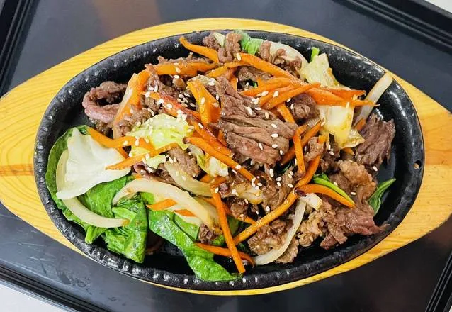 Bulgogi Korean BBQ beef sizzling on a hot plate at Diane's Kitchen in Saskatoon, SK